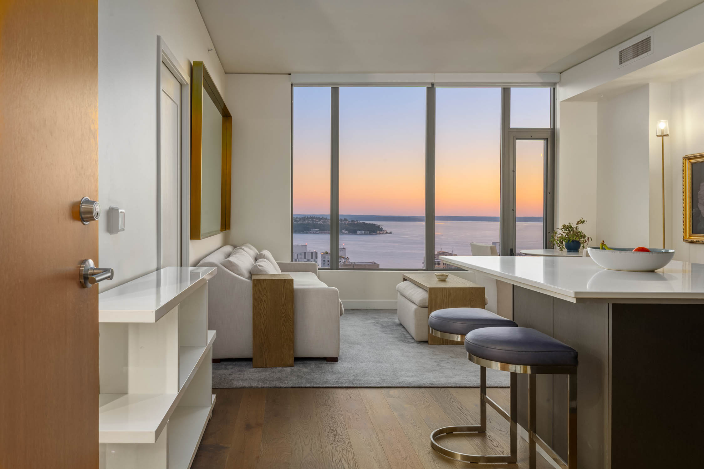 Staged SPIRE 3305 living area with Elliott Bay light at dusk